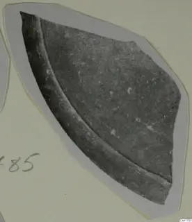 Cypro-Hell. II sherd: a curved fragment of dark pottery with a raised ridge, mounted on a card