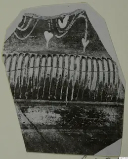 Pottery sherd with white painted swags and drop-shaped motifs above a band of vertical ribbing