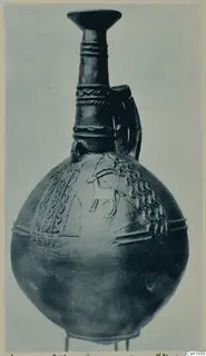Red Polished III jug from Vounous with a round body, flaring neck and incised animal motif on the shoulder