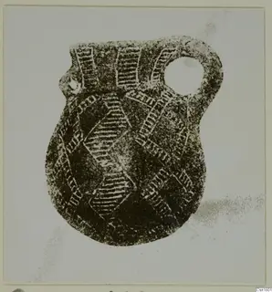 Red Polished III jug with a large loop handle and hatched incised decoration