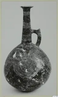 Red Polished III jug from Vounous with a tall neck, loop handle and incised concentric arcs on the body