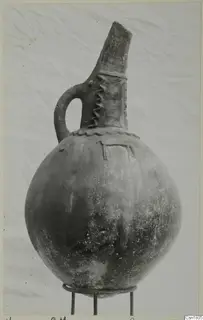 Round-bodied jug with a tall neck and strap handle, from Vounous (Red Polished III)