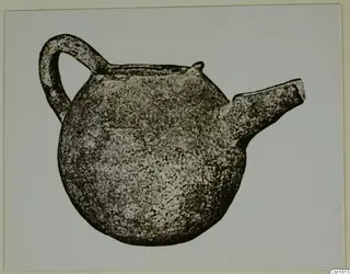 Red Polished III jug with a strap handle at the back and a short spout at the side, against a pale background.
