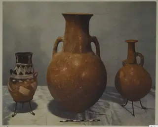 Three pottery vessels on wire stands with a scale bar in front, from Vounous, Red Polished I