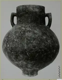 Red Polished I pottery vessel with two loop handles, from Vounous, photographed against a pale background