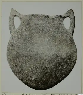 Pottery vessel of the Red Polished I type with a rounded body and two tall loop handles, photographed in grey tones