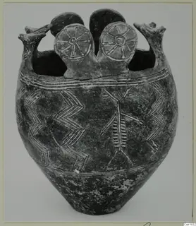 Pottery Red Polished I vessel with white-painted chevrons and a branched motif, with spoked discs and upright projections on the rim