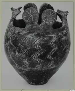Pottery vessel Red Polished I with two beaked handles, two spoked discs on top and zigzag bands on the body