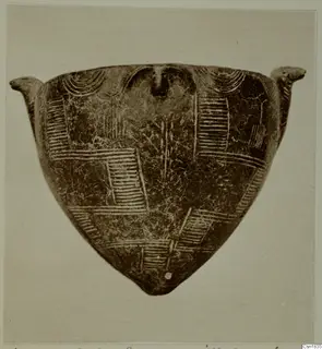 Red Polished I pottery object, triangular in outline, with two small lugs and incised hatched and arc patterns