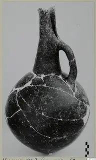 Red Polished I Stewart vessel from Vounous with a long neck and a single loop handle, mended from pieces