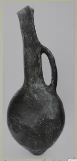 Red Polished I vessel from Vounous: a dark jug with a long neck and a single loop handle