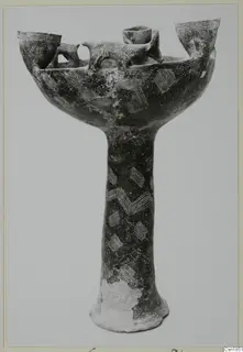 Pottery Red Polished I: a stemmed pottery vessel with a wide bowl, upright openings around the rim and incised hatched decoration