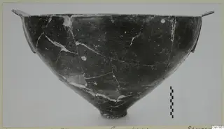 Dark polished bowl with two small horizontal handles at the rim, from Vounous
