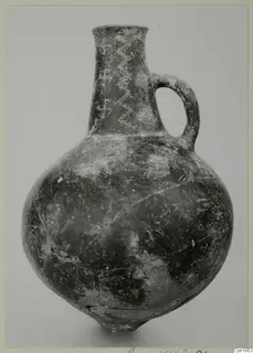 Red Polished I pottery jug with a single loop handle and pale zigzag and hatched decoration on the neck