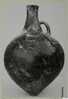 Red Polished I vessel with a tall neck and single loop handle, photographed against a plain background