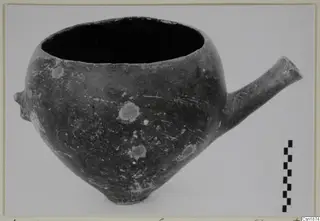 Pottery Red Polished I vessel from Vounous, with a tubular spout projecting to the right and a small lug on the left side
