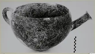 Red Polished I pottery vessel with a loop handle on the left and a flaring tubular spout on the right