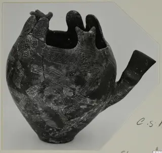 Red Polished I pottery vessel from Vounous with a tubular spout, a modelled head and incised zigzag and chevron patterns