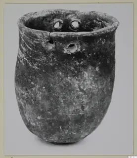 Red Polished I vessel from Vounous 153.3, with a flared rim and small holes near the top