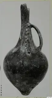 Pottery vessel with a tall neck, single loop handle and incised feather-like bands on the body