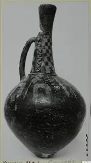 Jug from Vounous with a tall neck, strap handle and incised and applied decoration