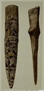 Two elongated objects side by side: the left with incised chevron bands, the right with spiral motifs on its flat top