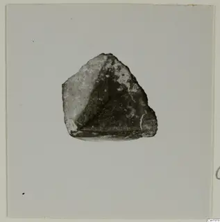 Fragment of a chisel of uralite porphyrite from Kythrea, shown on a pale mount