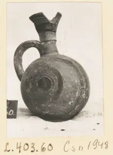 Jug from Lapithos with a flared spout, loop handle and concentric grooves on the rounded body