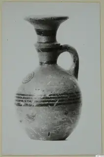 Jug in Pottery Black-on-Red I-III from the Kastros tombs at Lapithos, with black painted bands and a flared neck