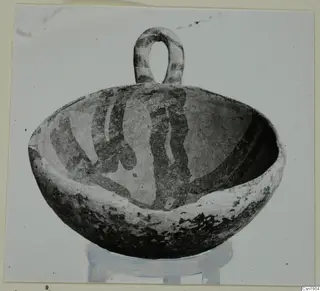 Pottery bowl with a loop handle and dark painted bands, from Ayios Iakovos