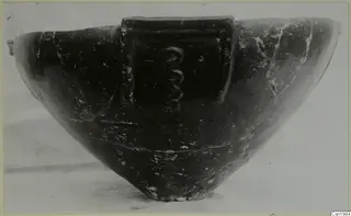 Pottery Red Polished III bowl with a raised panel bearing a coiled relief on its side