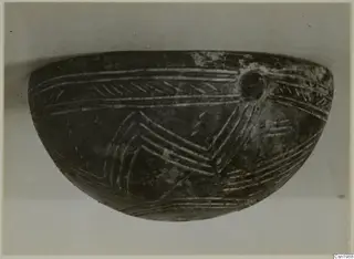 Red Polished III Bowl, a dark bowl with incised chevron and line decoration and a round lug on the upper right.