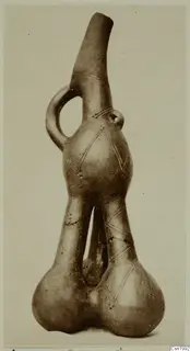 Red Polished III amphora from Vounous, with a tall spout, loop handle and incised diamond pattern.