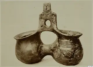Red Polished III amphora from Vounous: a double-bodied clay vessel with a small human figure rising from its central bridge