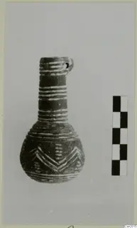 Pottery vessel with a narrow neck, a pierced lug at the rim and light banded and chevron decoration, beside a scale bar