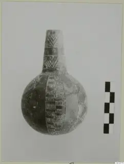Pottery vessel with a tall narrow neck and incised decoration, shown beside a checkered scale bar