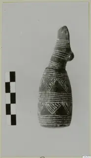 Pottery vessel with a tall narrow neck and white painted bands and triangles, beside a scale bar