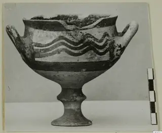 White Painted I bowl on a low stem foot, with two handles and wavy painted bands around the body