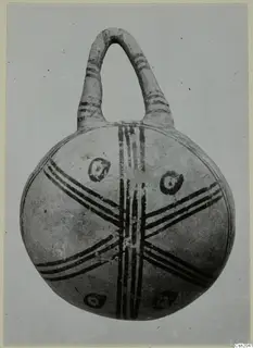 White Painted pottery vessel with a tall loop handle and dark painted bands across the body