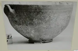 Foreign Red Slip bowl from Amathus with a single handle and ribbed rim, shown in side view
