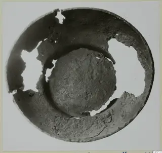 Broken bowl seen from above, with its rim missing in several places