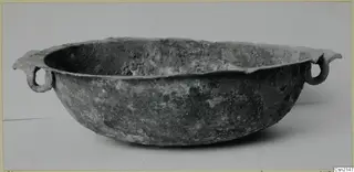 Corroded metal bowl with two ring handles, from Marion tombs 31–45
