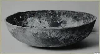 Bowl from Marion with a crusted interior, photographed on a pale surface