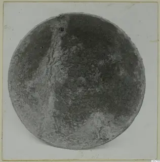 Bowl seen from above, with a mottled grey surface and a crack running down one side.