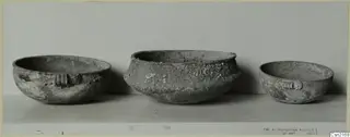 Three bowls of different sizes standing in a row, two with ridged handles