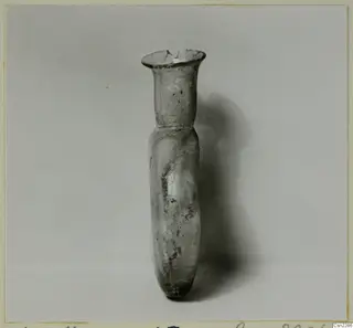 Blown glass vase with a flared rim and long narrow neck, photographed on a plain backdrop.