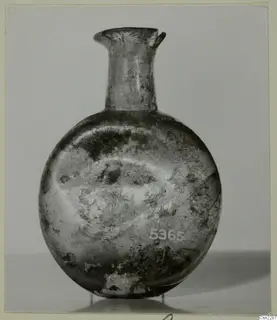 Blown glass flask with a short flared neck and rounded body, shown on a plain grey background.