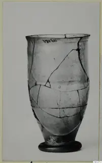 Blown glass vessel with a flared rim and ring foot, repaired from broken pieces