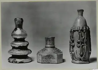 Three blown glass vessels of different shapes, the right one with trailed thread decoration