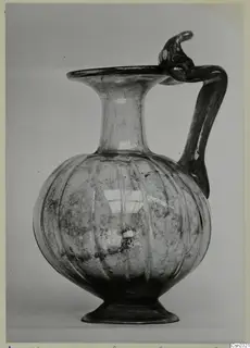 Blown glass jug with a ribbed globular body, flaring rim and twisted handle, from Amathus